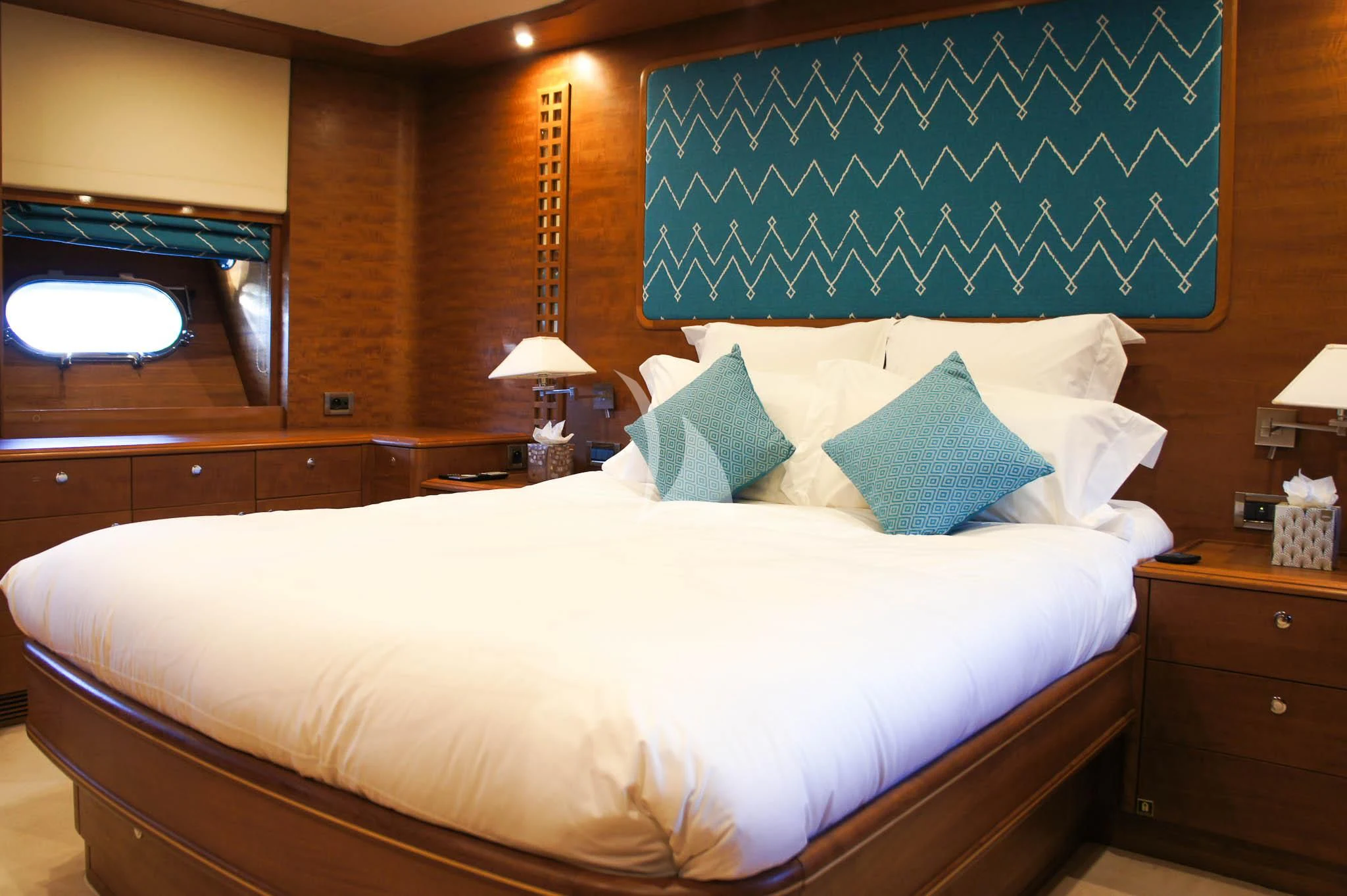 a bed with blue and white sheets aboard LADY EMMA Yacht for Sale