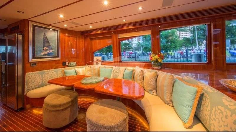 a living room with a table and chairs aboard DREAM ON Yacht for Sale