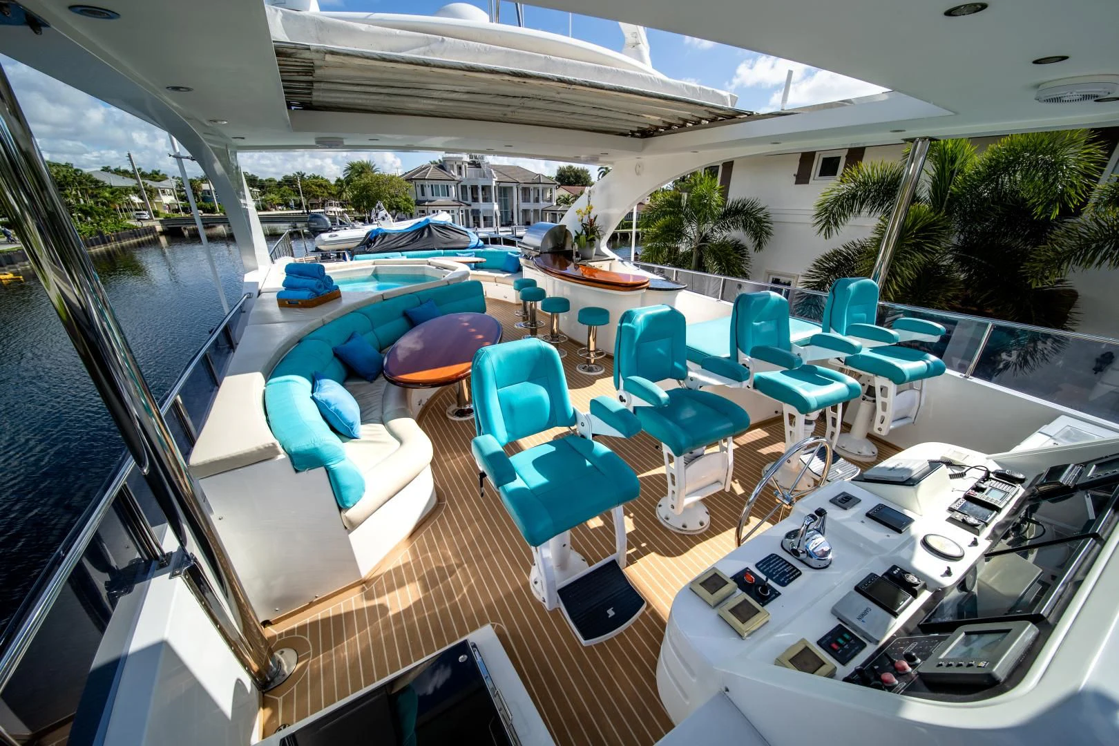 a patio with a lounge chair and umbrellas aboard DREAM ON Yacht for Sale