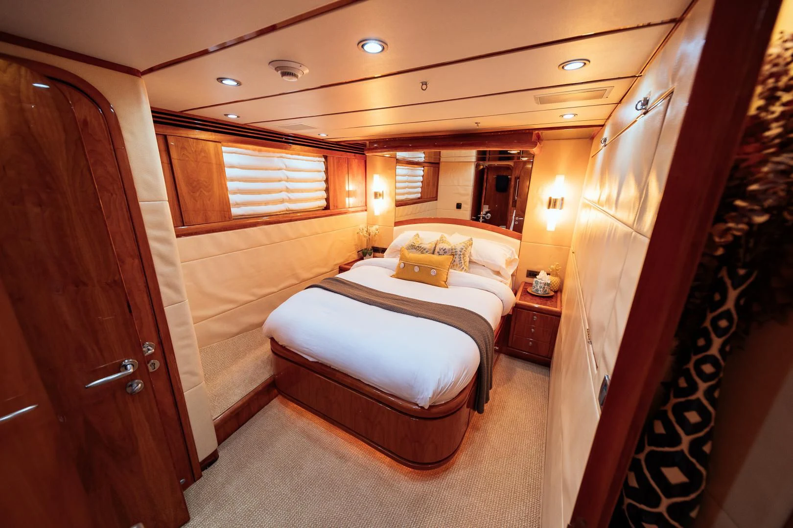 a bedroom with a bed and a mirror aboard DREAM ON Yacht for Sale