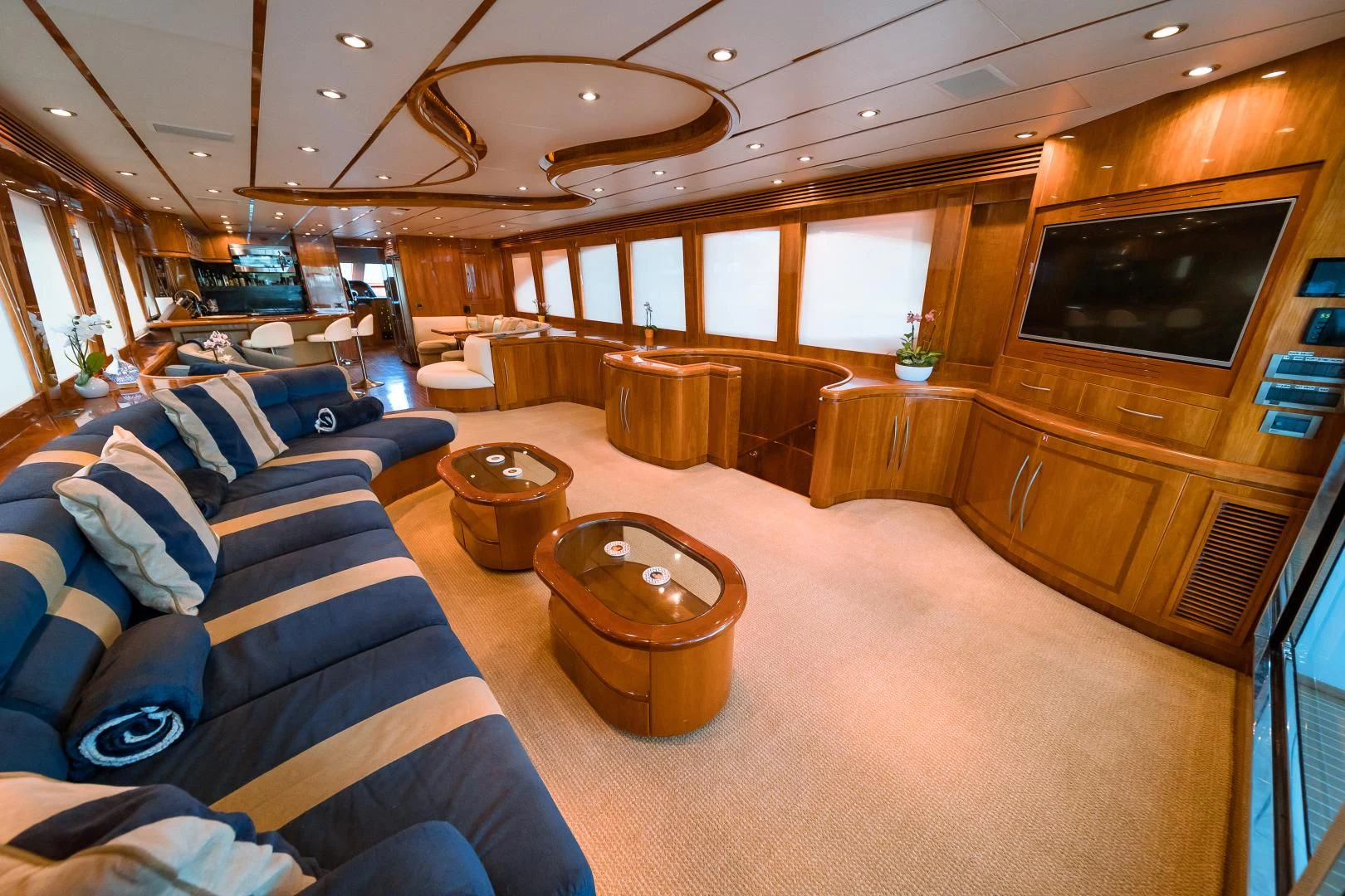 a living room with a large wood cabinet and a leather couch aboard DREAM ON Yacht for Sale