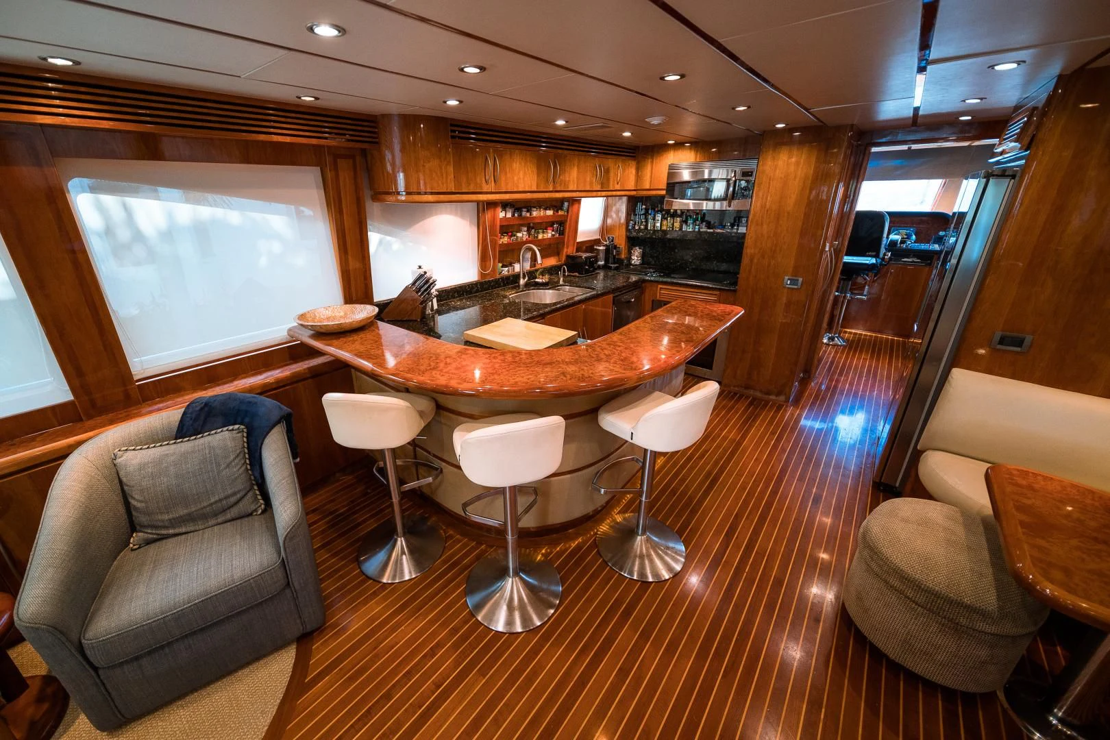 a large room with a bar and chairs aboard DREAM ON Yacht for Sale
