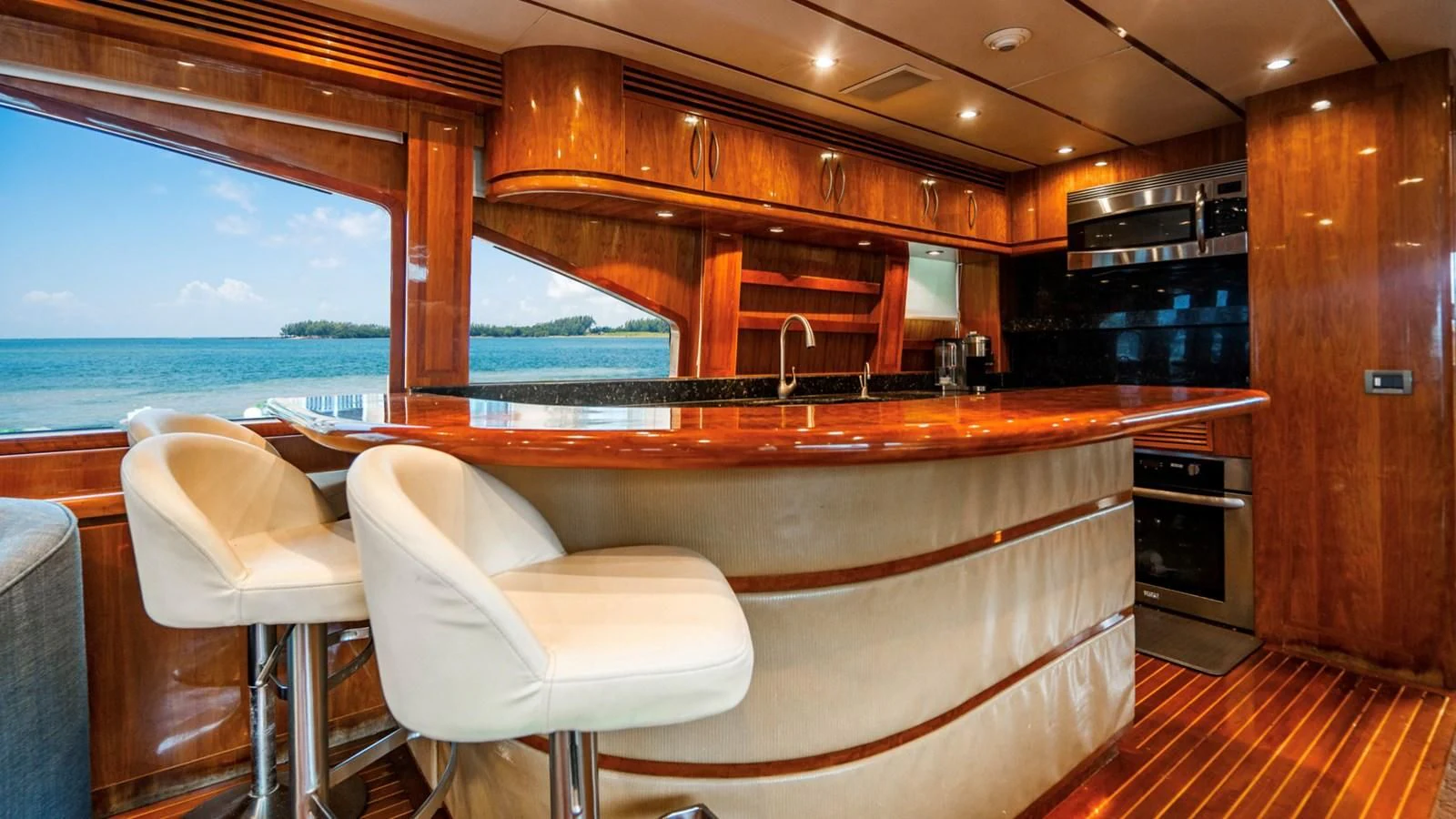 a room with a kitchen and a large window aboard DREAM ON Yacht for Sale