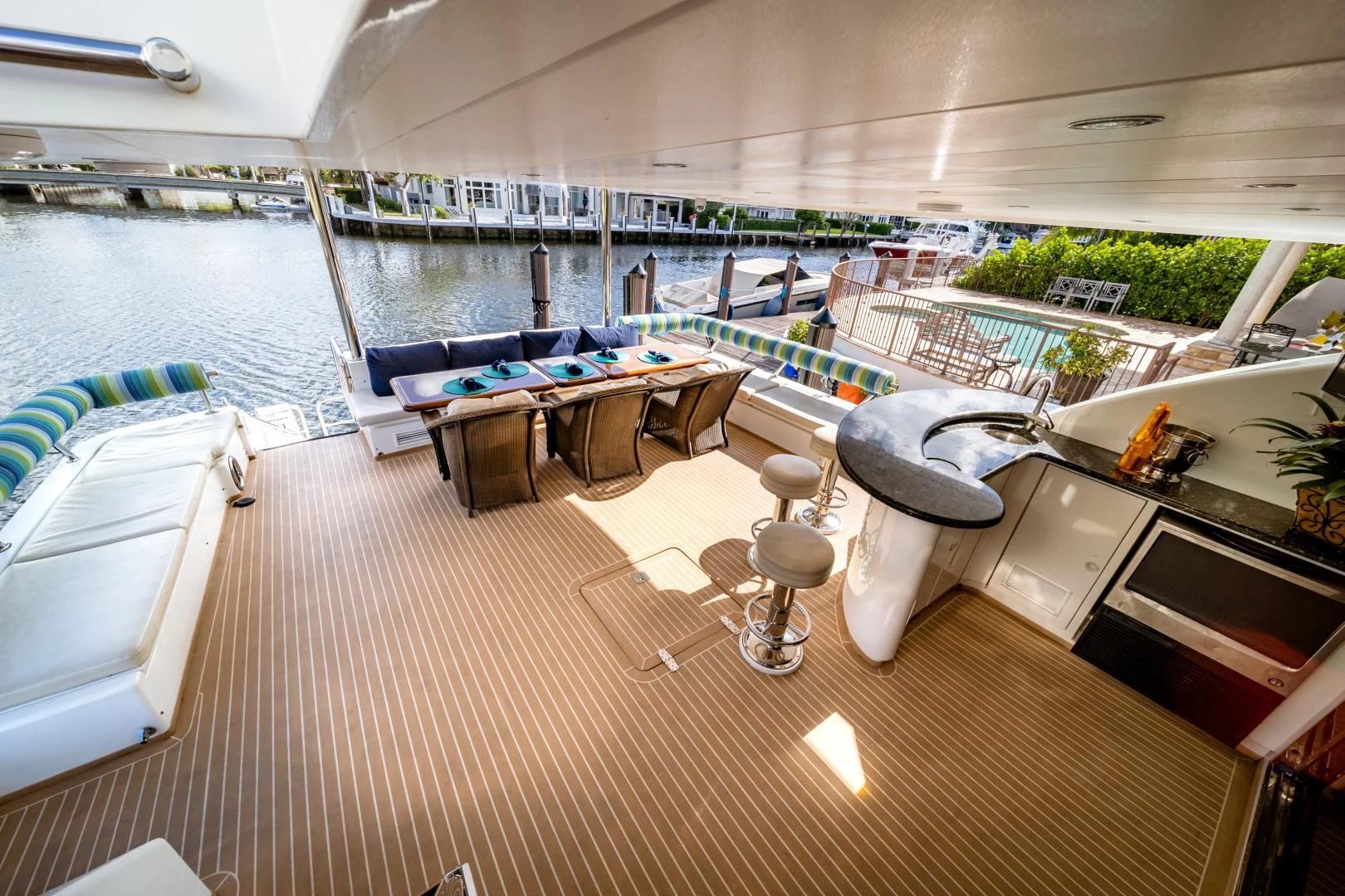 a room with a table chairs and a pool aboard DREAM ON Yacht for Sale