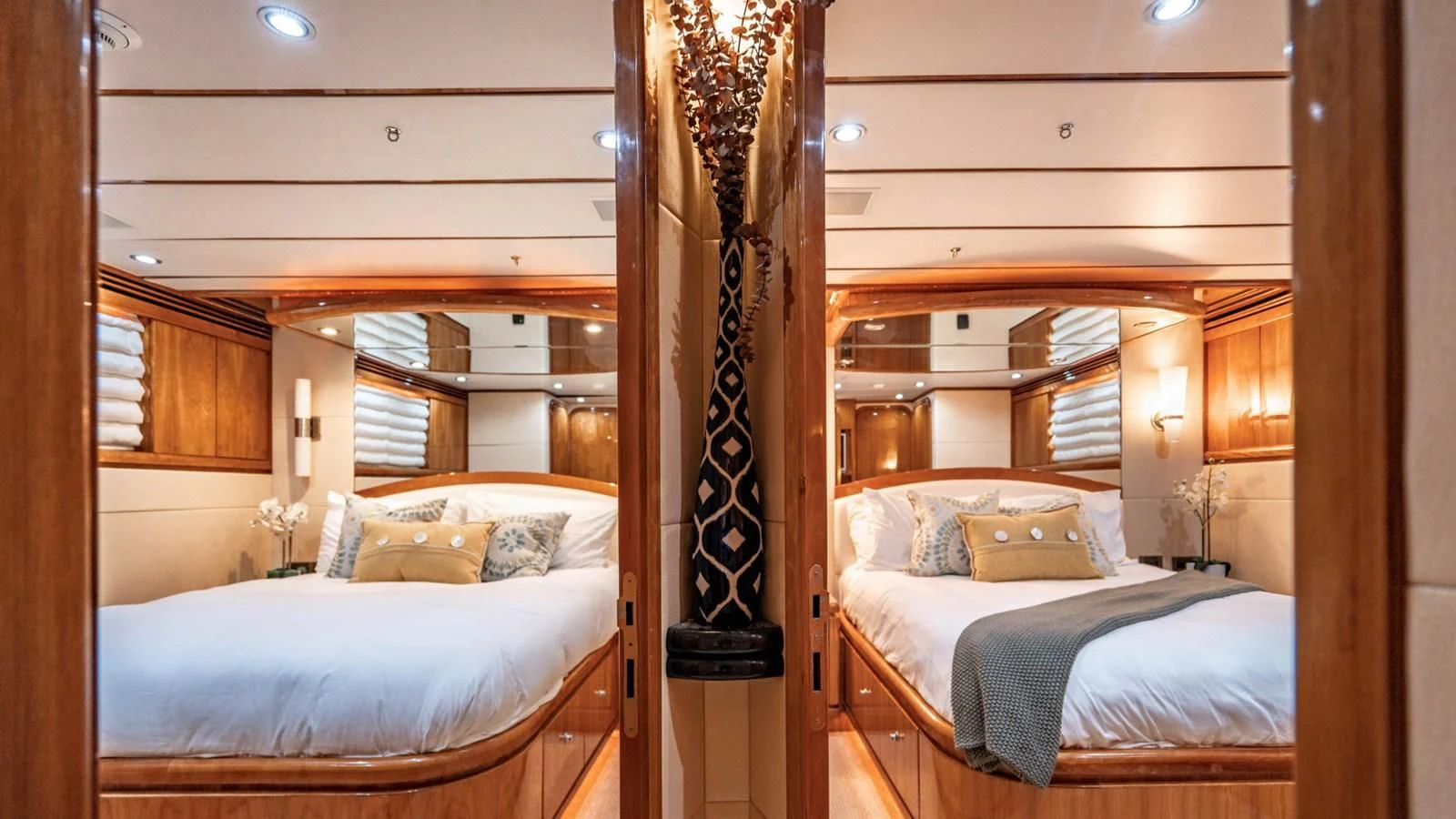 a bedroom with a bed and a wood headboard aboard DREAM ON Yacht for Sale