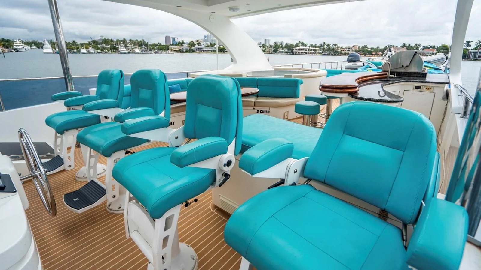 a boat deck with chairs and tables aboard DREAM ON Yacht for Sale