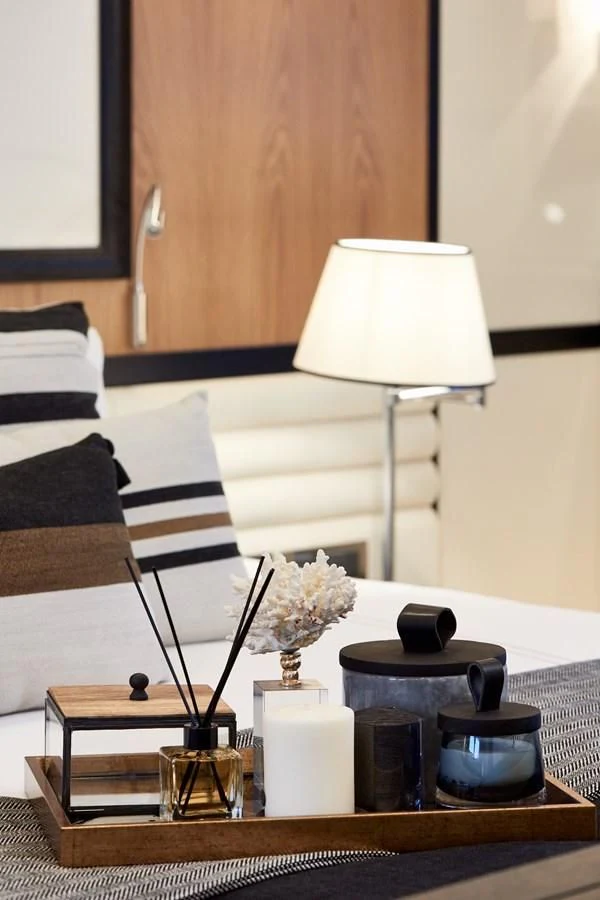 a table with a lamp and a vase with flowers on it aboard BERING 88/05 Yacht for Sale