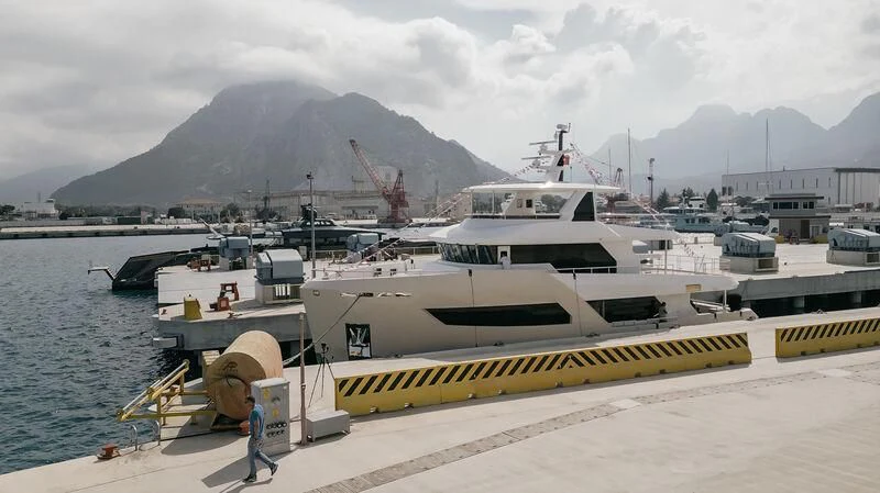 a boat docked at a pier aboard BERING 88/05 Yacht for Sale
