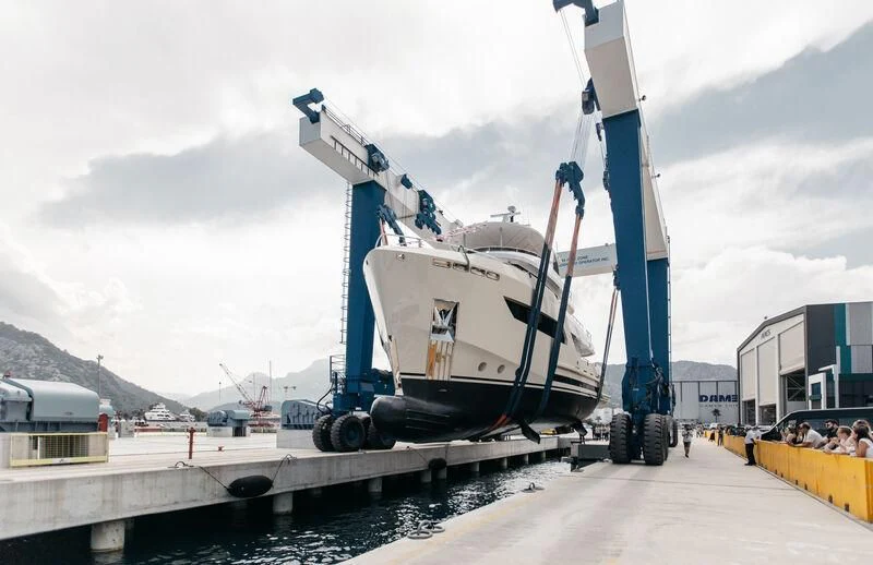 a large crane lifting a boat aboard BERING 88/05 Yacht for Sale