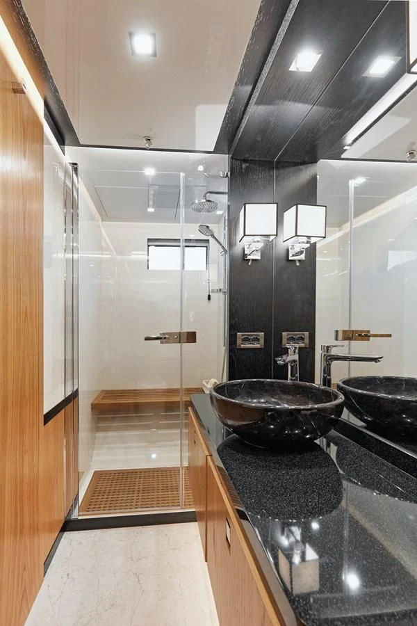 a modern bathroom with a large black bowl on a black countertop aboard BERING 88/05 Yacht for Sale