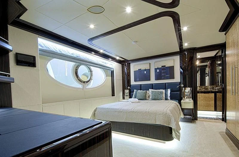 a room with a bed and a mirror aboard PERSISTENCE Yacht for Sale