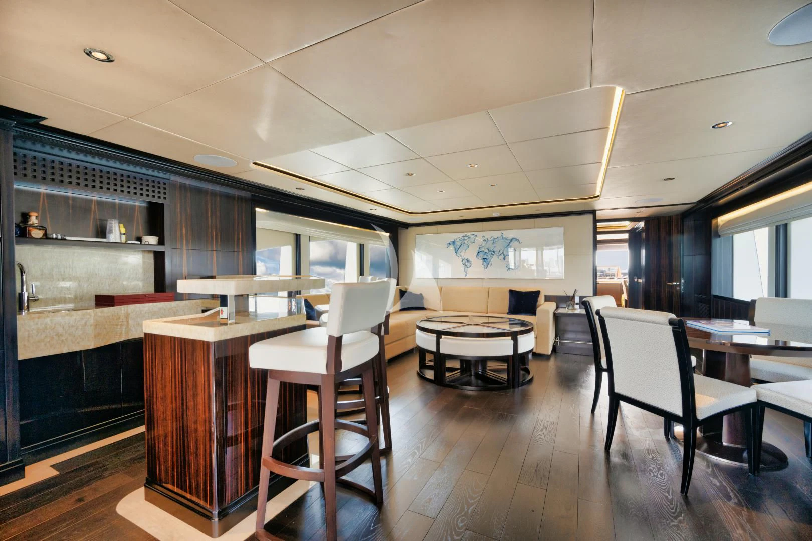 a room with a table chairs and a large window aboard PERSISTENCE Yacht for Sale