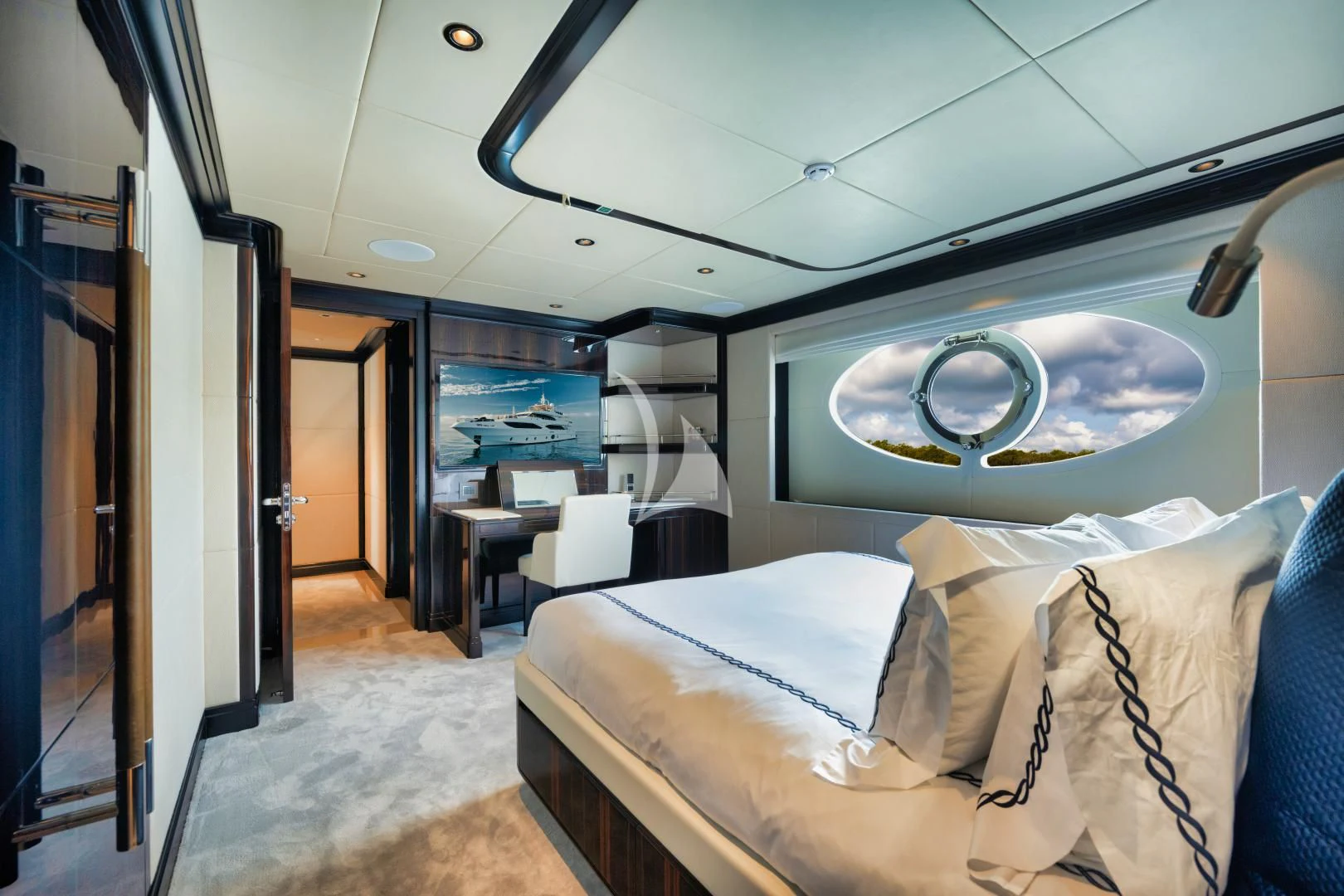 a bedroom with a large mirror above the bed aboard PERSISTENCE Yacht for Sale