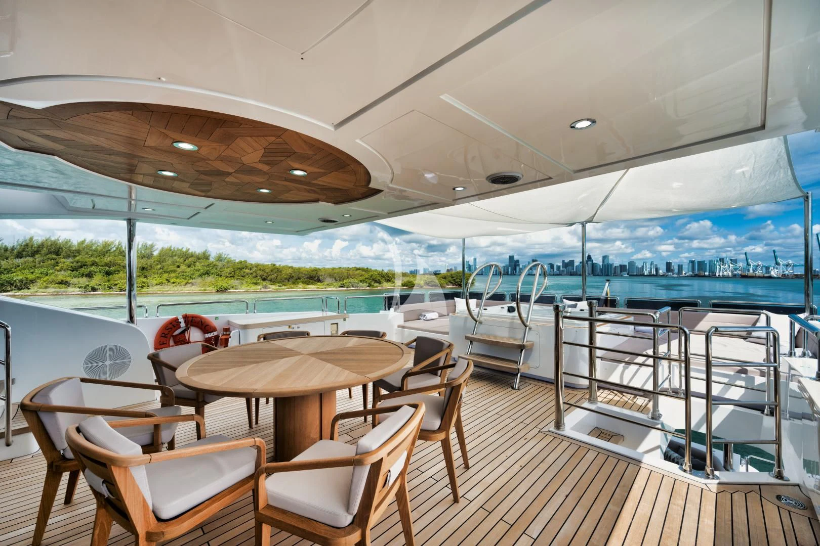 a deck with a table and chairs aboard PERSISTENCE Yacht for Sale