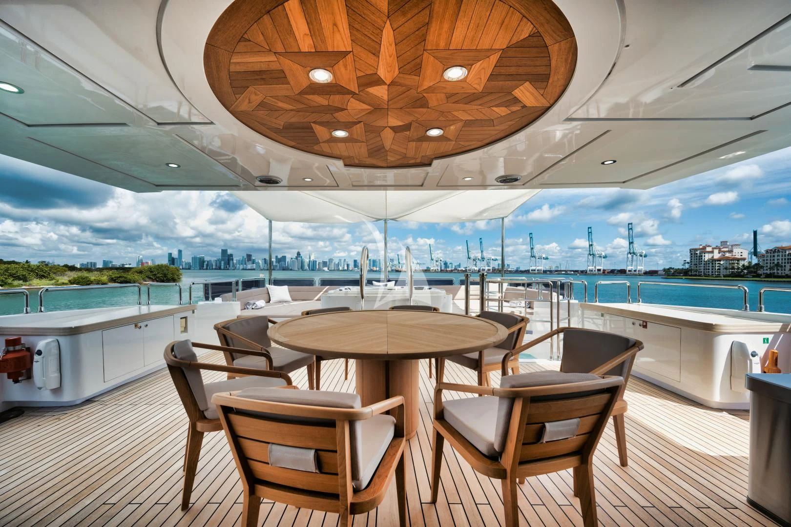 a table and chairs on a deck overlooking a body of water aboard PERSISTENCE Yacht for Sale