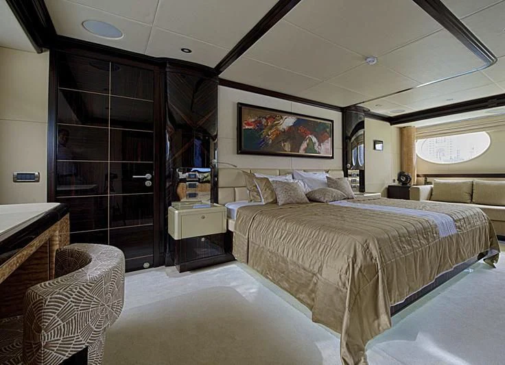a bedroom with a bed and a chair aboard PERSISTENCE Yacht for Sale