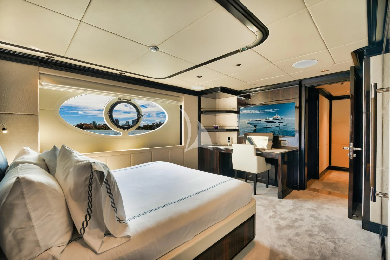 a room with a bed and desk aboard PERSISTENCE Yacht for Sale