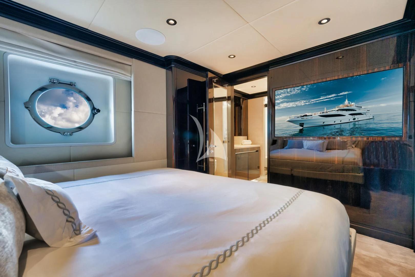 a bed with a large screen aboard PERSISTENCE Yacht for Sale