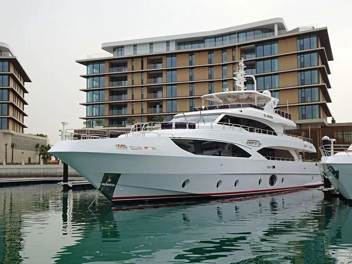 a large white boat in a harbor aboard PERSISTENCE Yacht for Sale