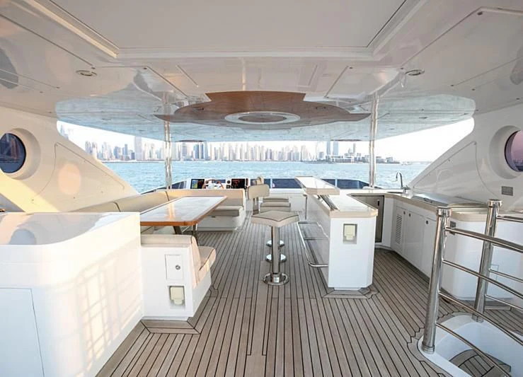 a ship with a deck and chairs aboard PERSISTENCE Yacht for Sale