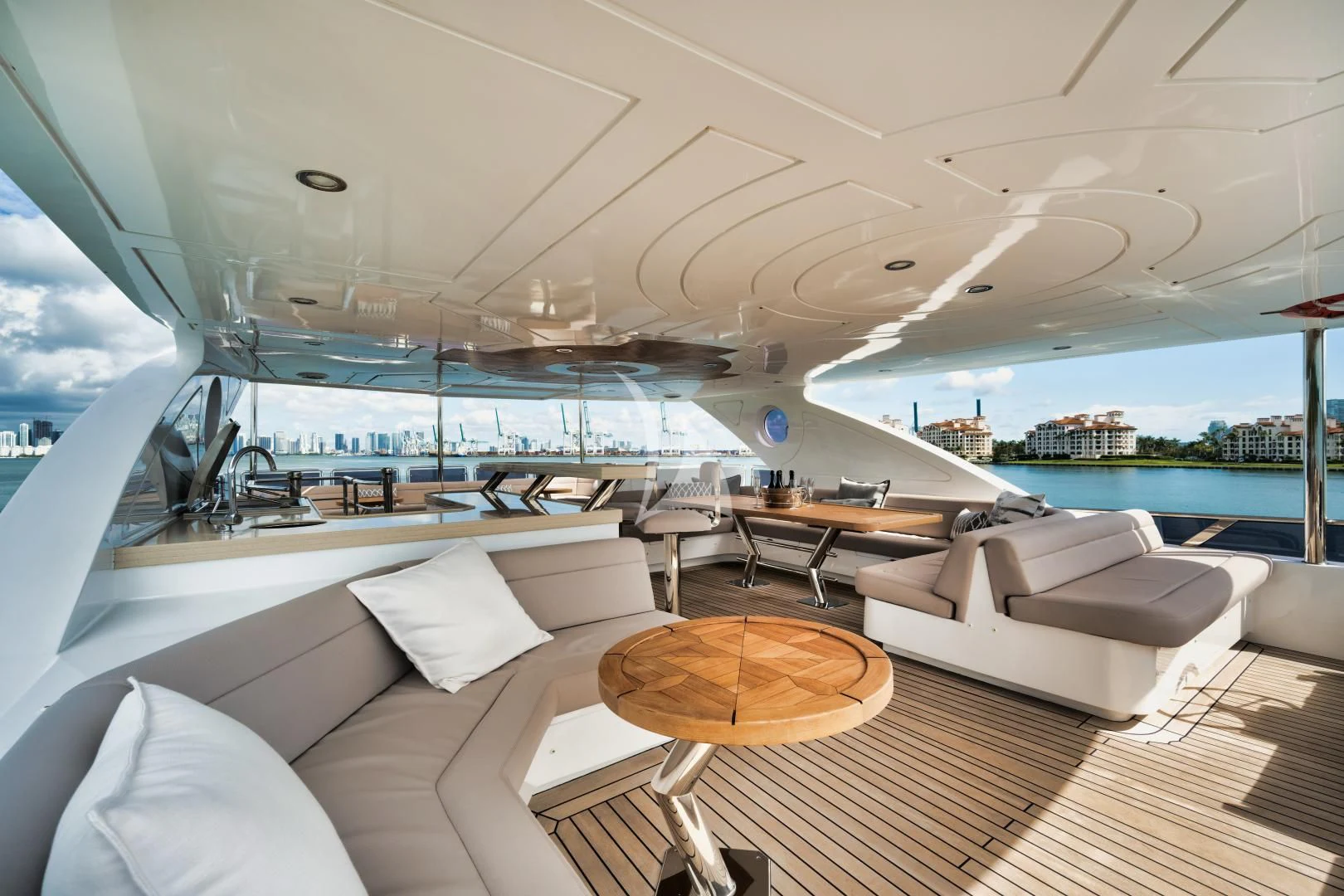 a room with a large window and a table with chairs and a view of the water aboard PERSISTENCE Yacht for Sale