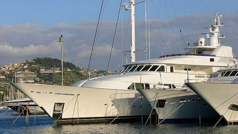 a white yacht docked aboard AMBITION Yacht for Sale