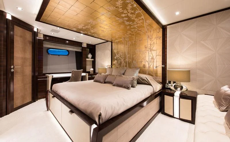 a room with a bed and a desk aboard SILVER WIND Yacht for Charter