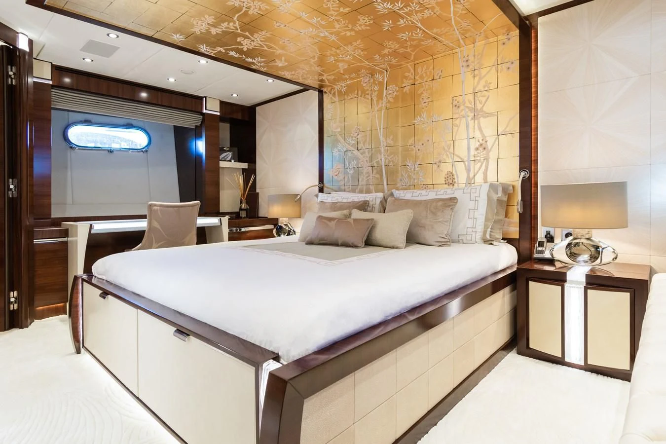 a bed with a white bed spread aboard SILVER WIND Yacht for Charter