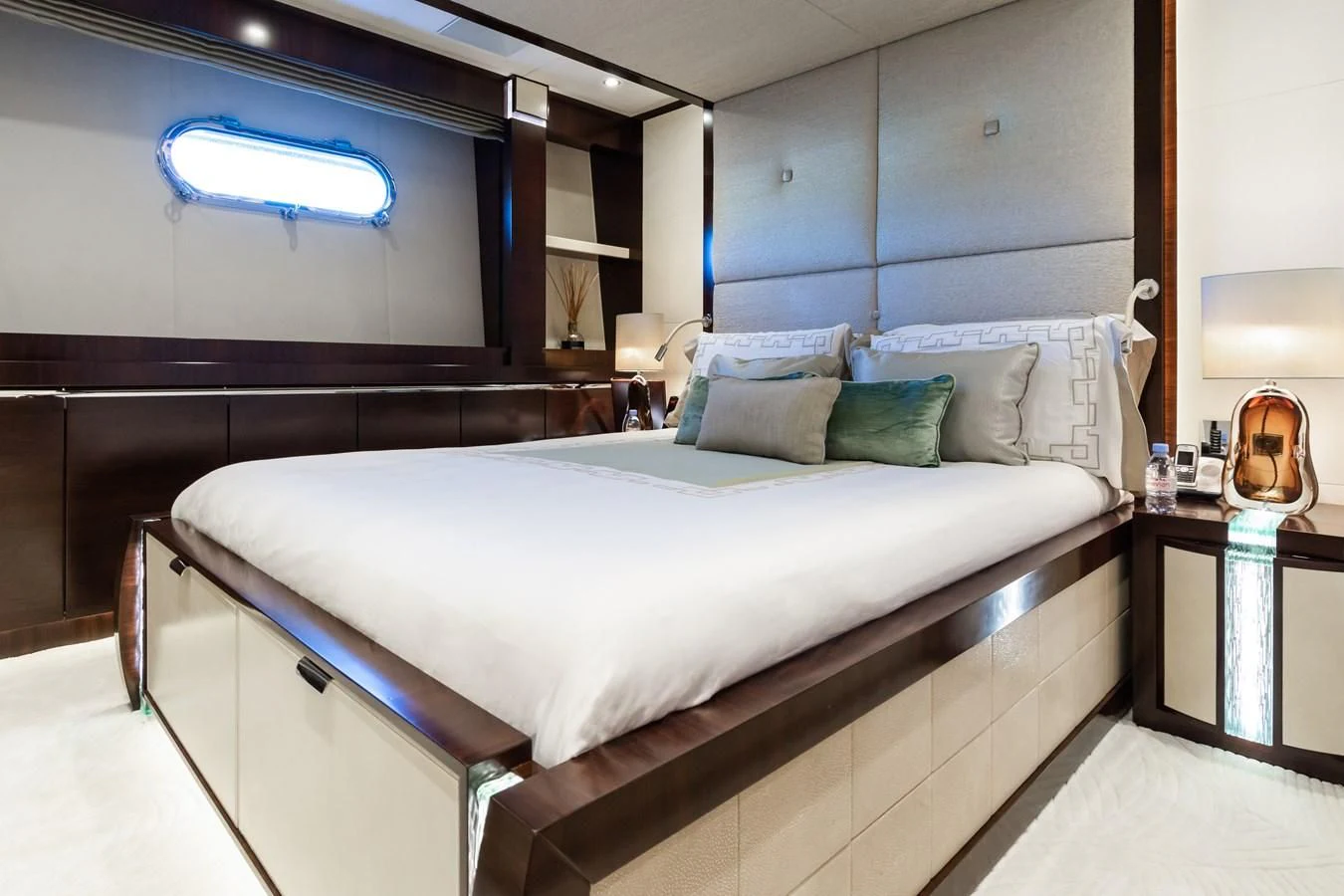 a bed with a white bed spread aboard SILVER WIND Yacht for Charter