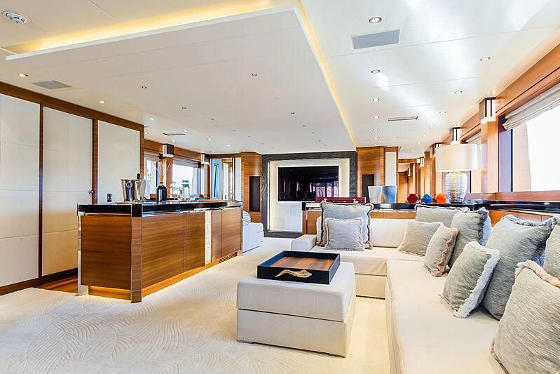 a living room with a large white sofa and a large wood cabinet aboard SILVER WIND Yacht for Charter