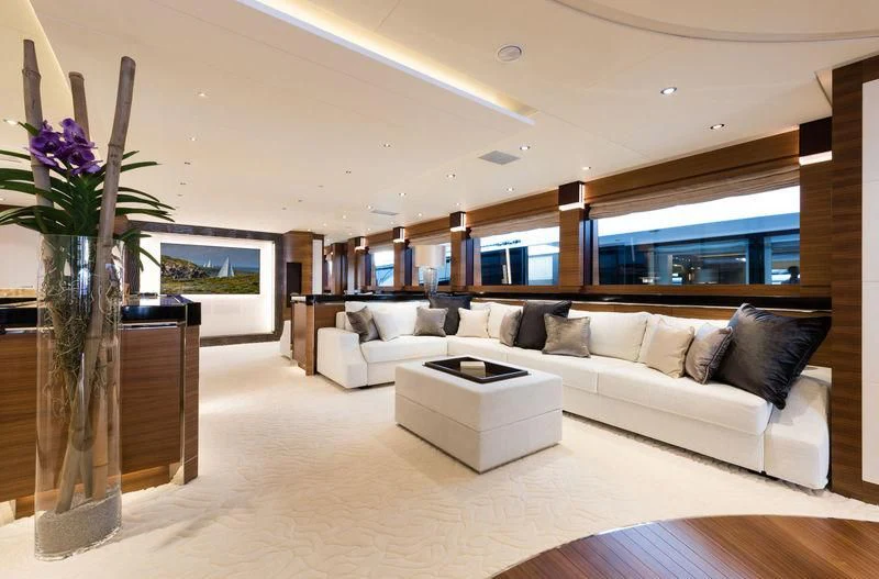 a living room with a white couch and a vase of flowers aboard SILVER WIND Yacht for Charter