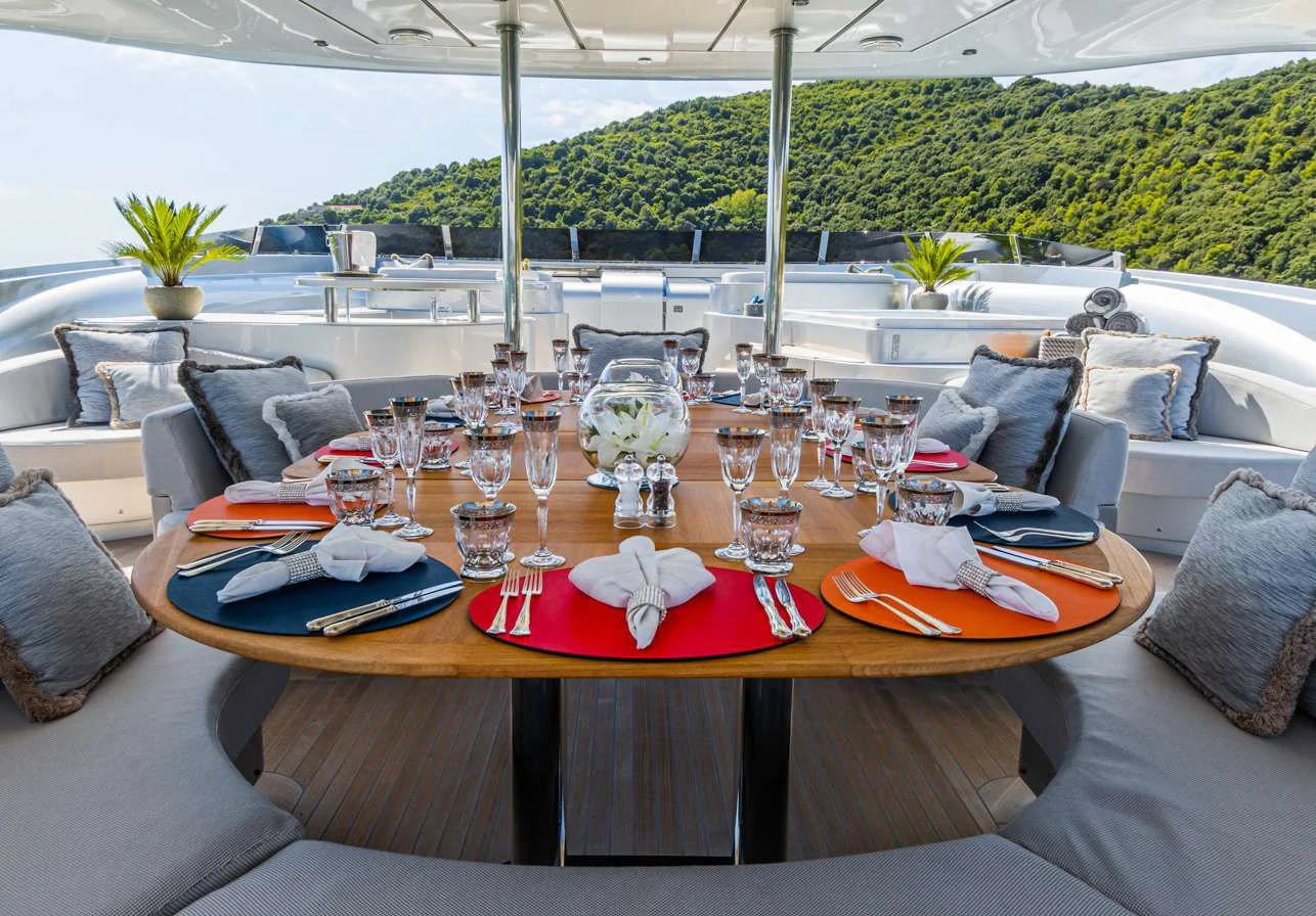 a table with wine glasses and pillows on it aboard SILVER WIND Yacht for Charter