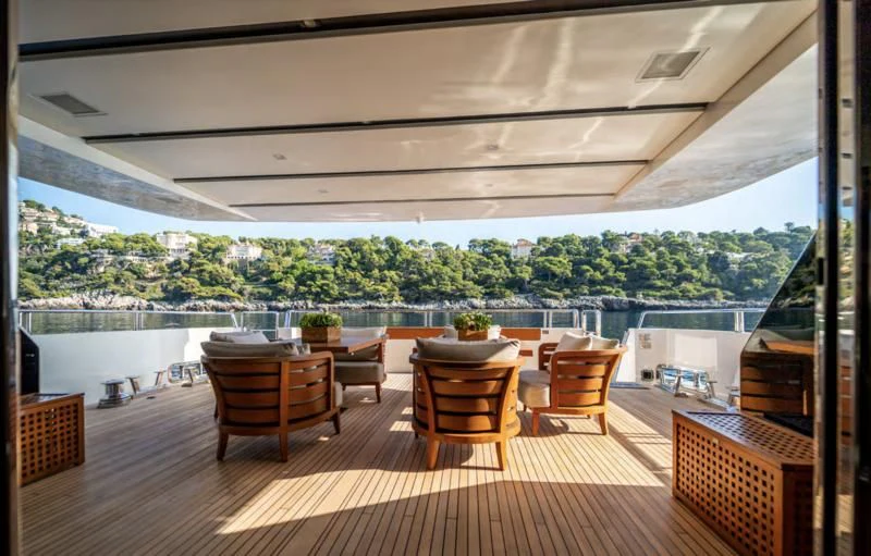 a deck with chairs and tables aboard BLUES Yacht for Sale