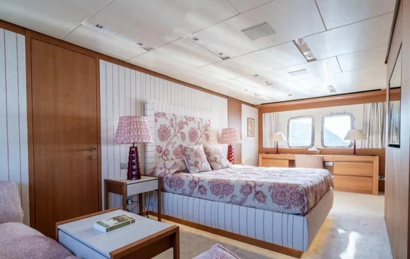 a bedroom with a bed and a desk aboard BLUES Yacht for Sale
