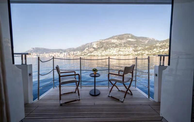 a deck with chairs and a table on it aboard BLUES Yacht for Sale