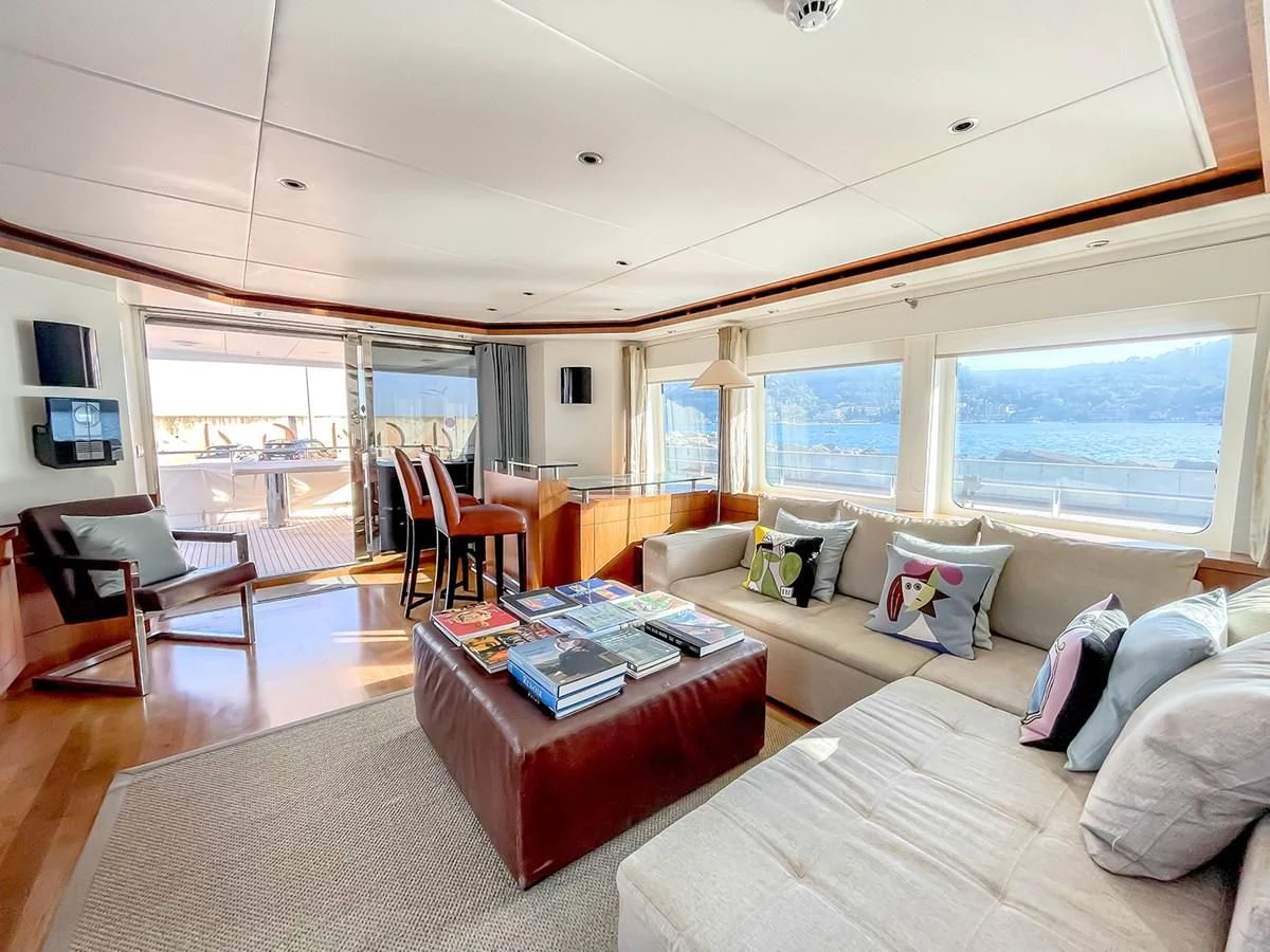 a living room with a couch and a coffee table aboard VERSE Yacht for Sale