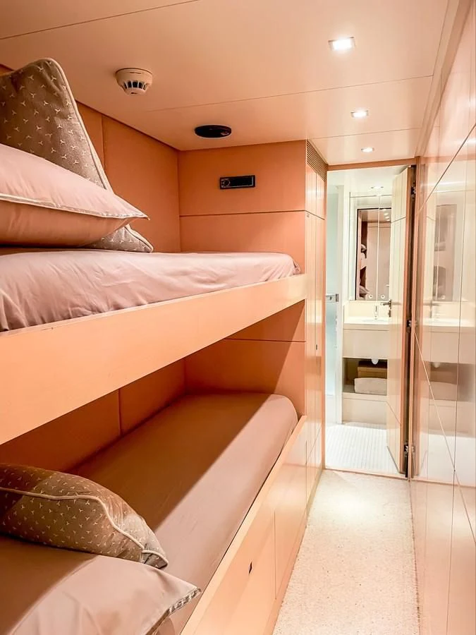 a room with a bed and a mirror aboard VERSE Yacht for Sale