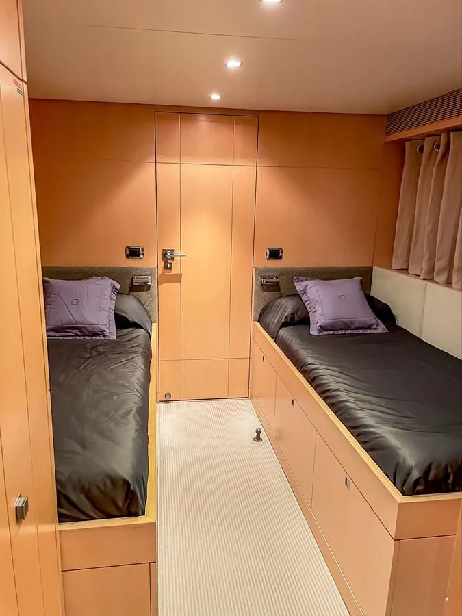 a bedroom with a bed and a mirror aboard VERSE Yacht for Sale