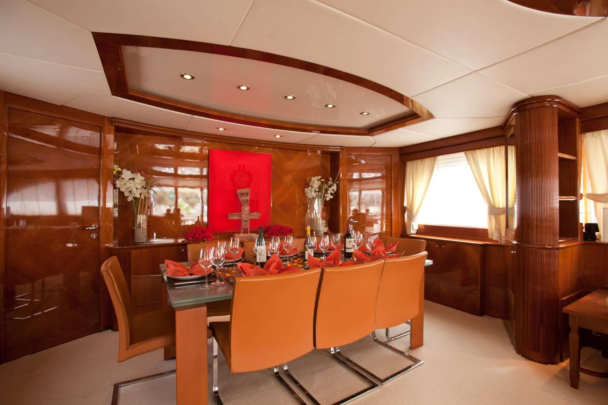 a restaurant with tables and chairs aboard SUPER Yacht for Charter