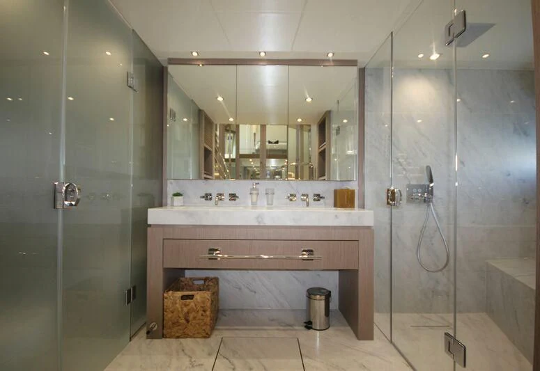 a bathroom with a large mirror aboard AMOUR I Yacht for Sale