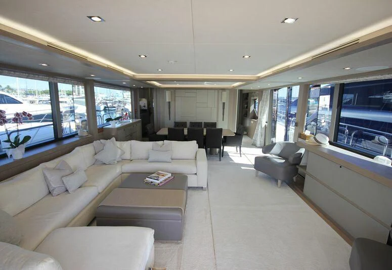 a living room with a large window aboard AMOUR I Yacht for Sale