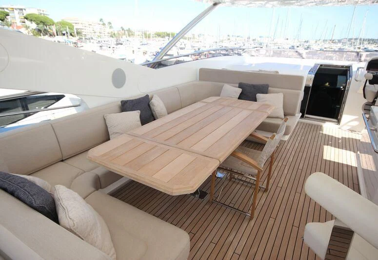 a deck with a couch and a table on it aboard AMOUR I Yacht for Sale