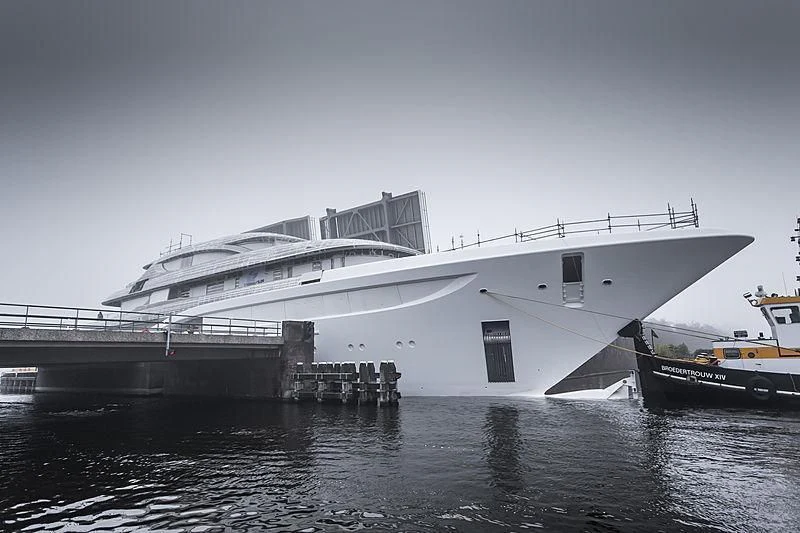 a large ship docked at a pier aboard PODIUM Yacht for Sale