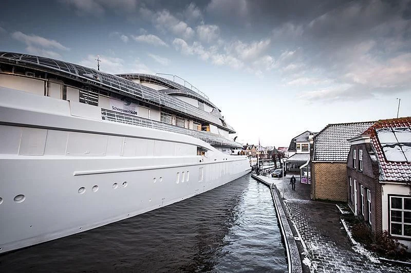 a boat is parked on the side of a river aboard PODIUM Yacht for Sale