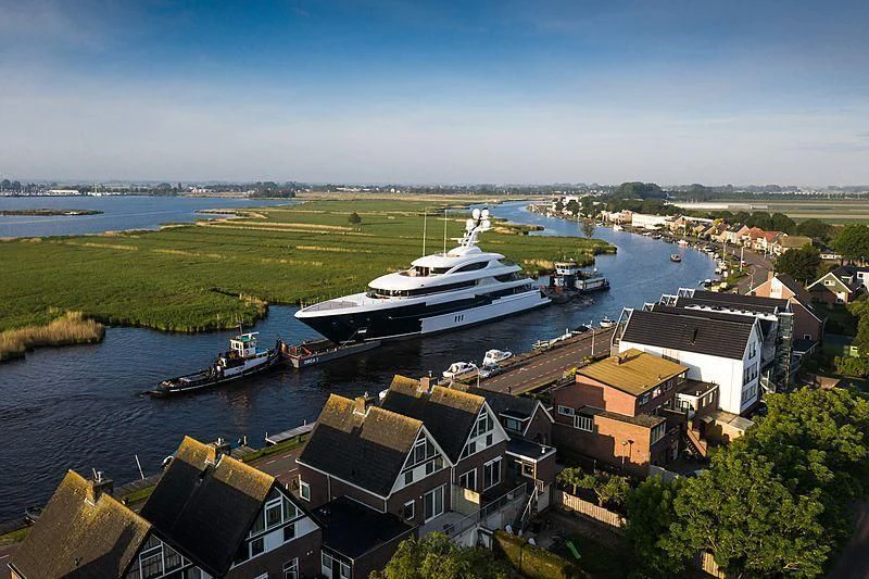 a large ship docked at a port aboard PODIUM Yacht for Sale