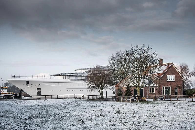a building with a snowy field in front of it aboard PODIUM Yacht for Sale