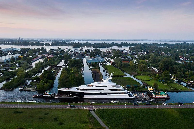 a large building with a body of water in the background aboard PODIUM Yacht for Sale