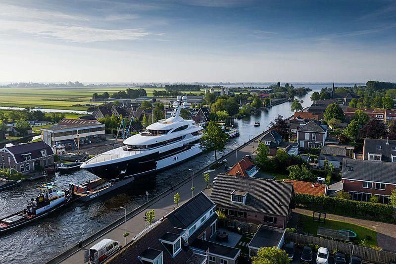 a large ship docked in a harbor aboard PODIUM Yacht for Sale