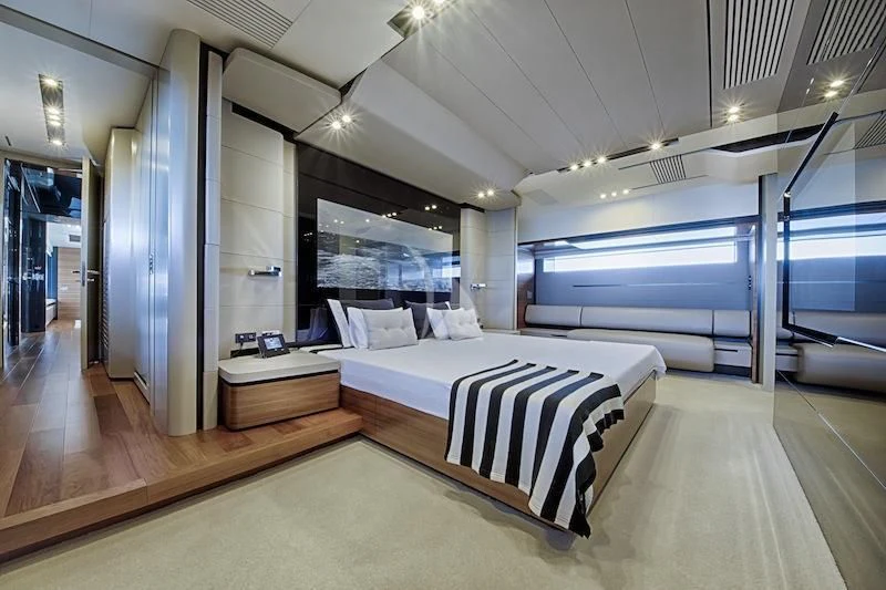 a room with a bed and a large window aboard FUSION Yacht for Charter