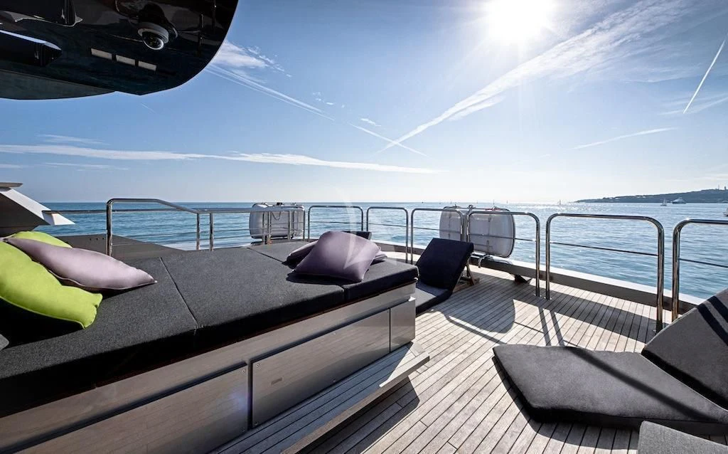 a deck with a view of the ocean and the ocean aboard FUSION Yacht for Charter